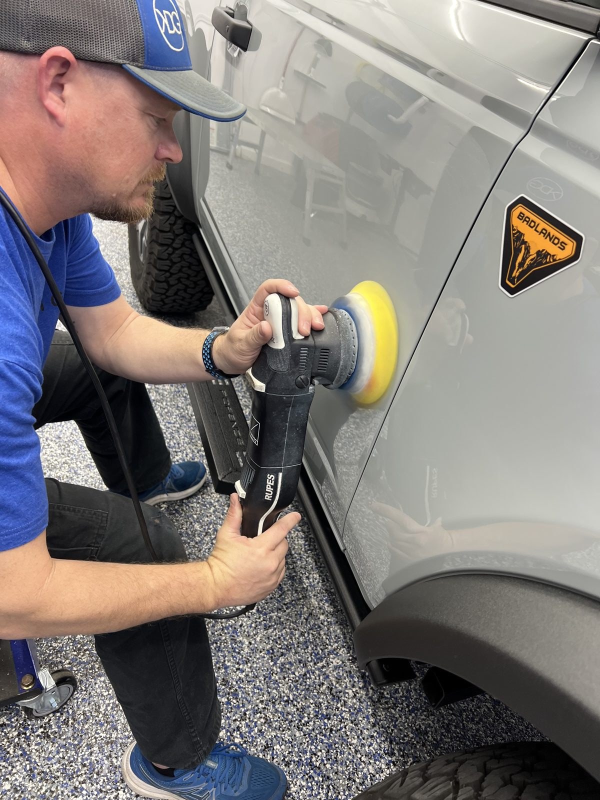 Kyle polishing a white car before coating